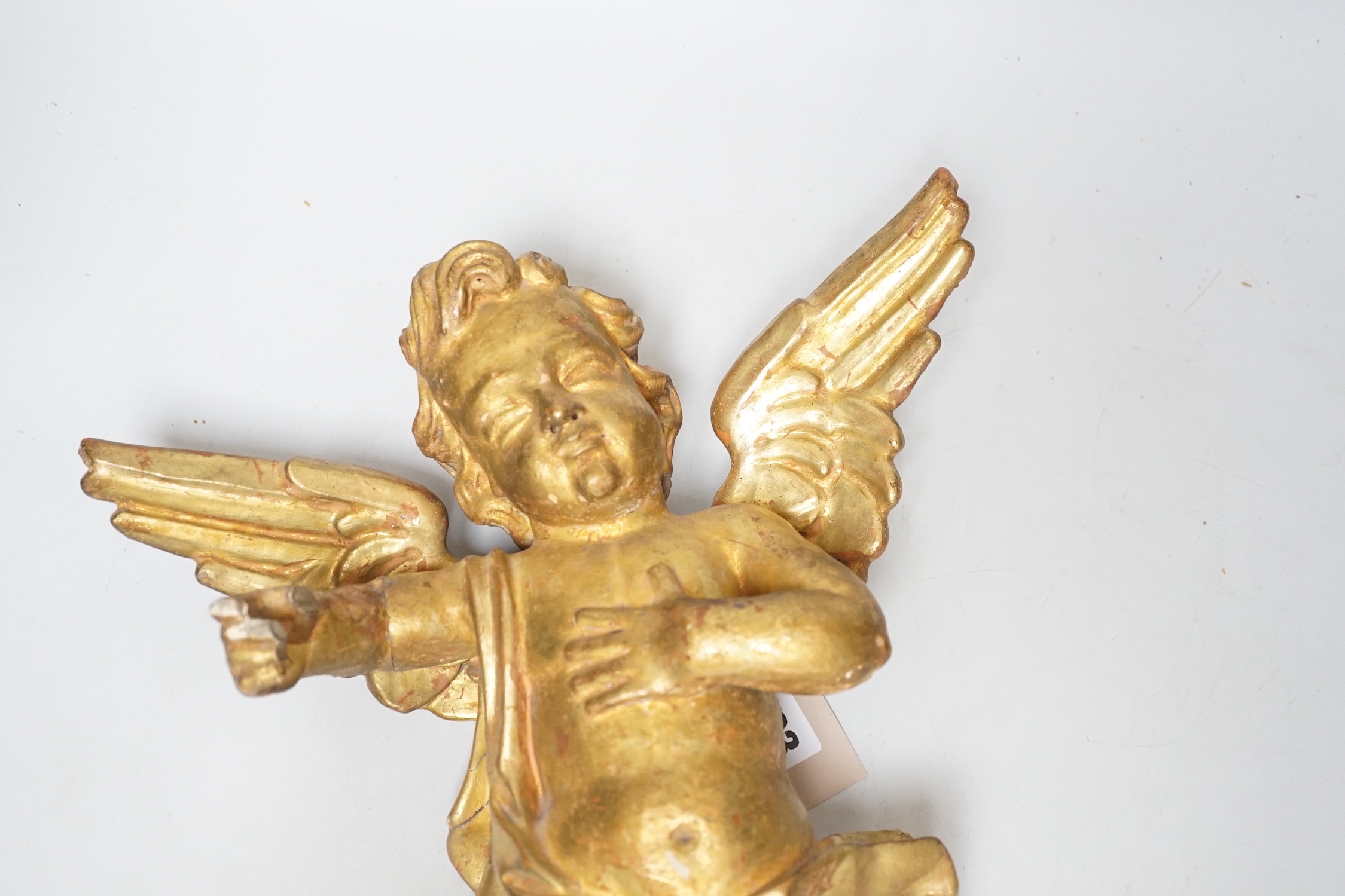 DO NOT RE-OFFER A Florentine carved gilt wood amorini, 39cm high